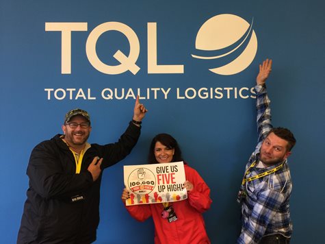 Morning Radio Show Hosts Smile And Point To The TQL Logo